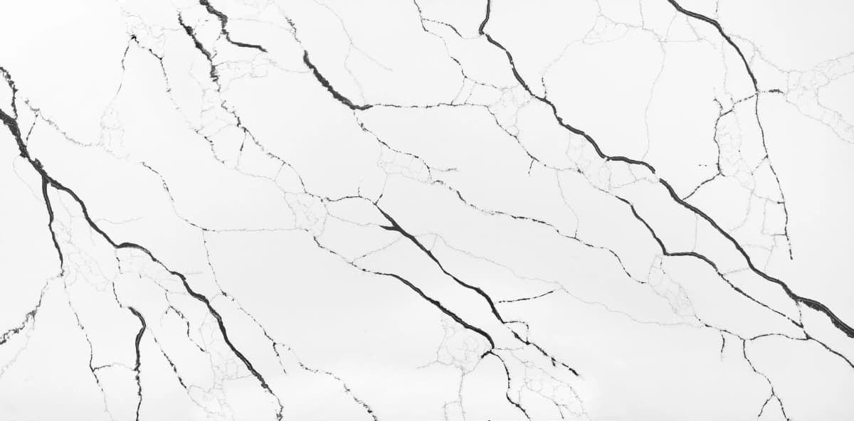 Introducing the Lux Noir quartz slab, evoking a sense of mystery and sophistication. Profound veins of silver and charcoal weave through the slab creating an interplay of light and darkness.