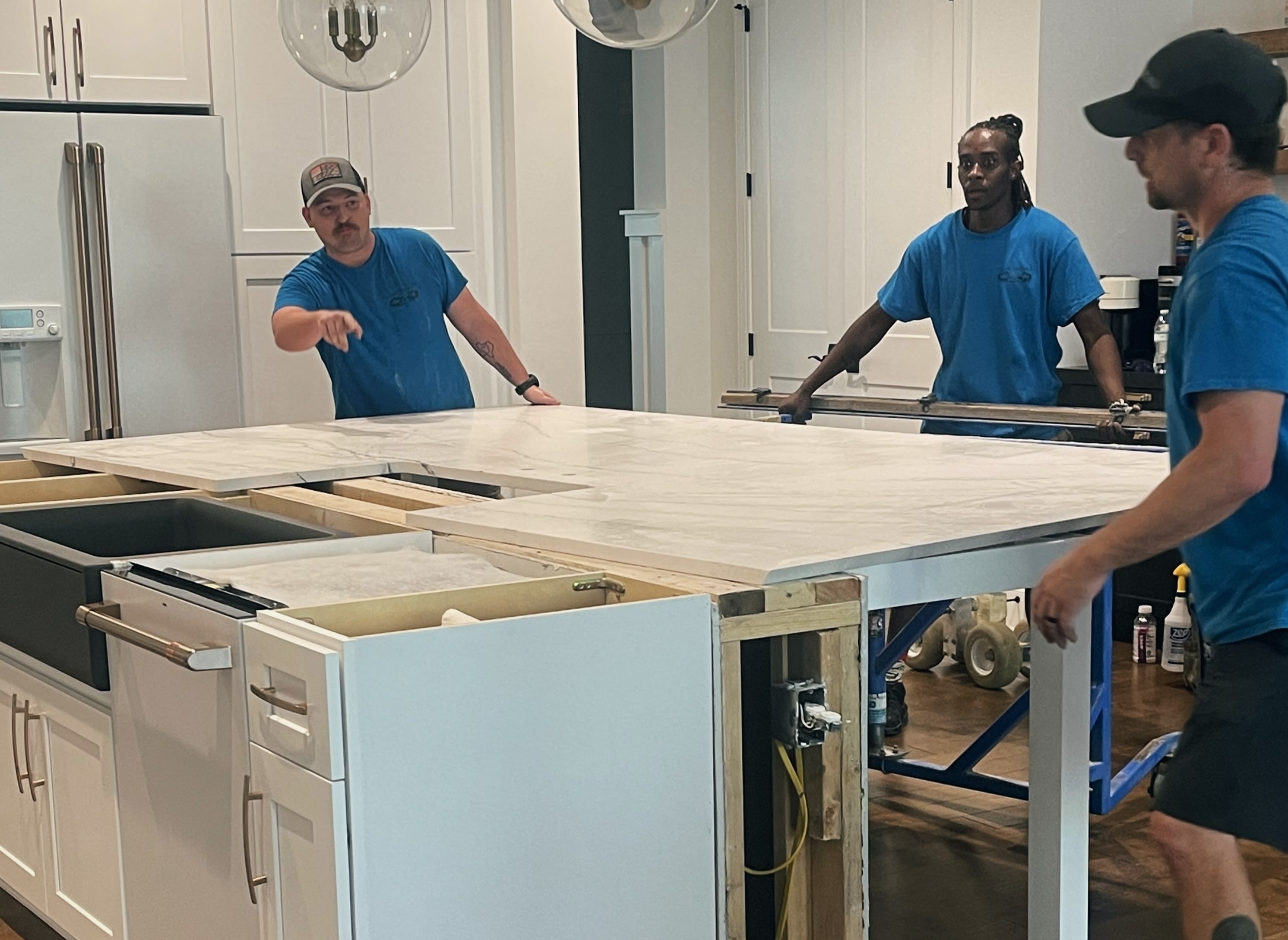 Image of three Granite Details' workers installing a countertop